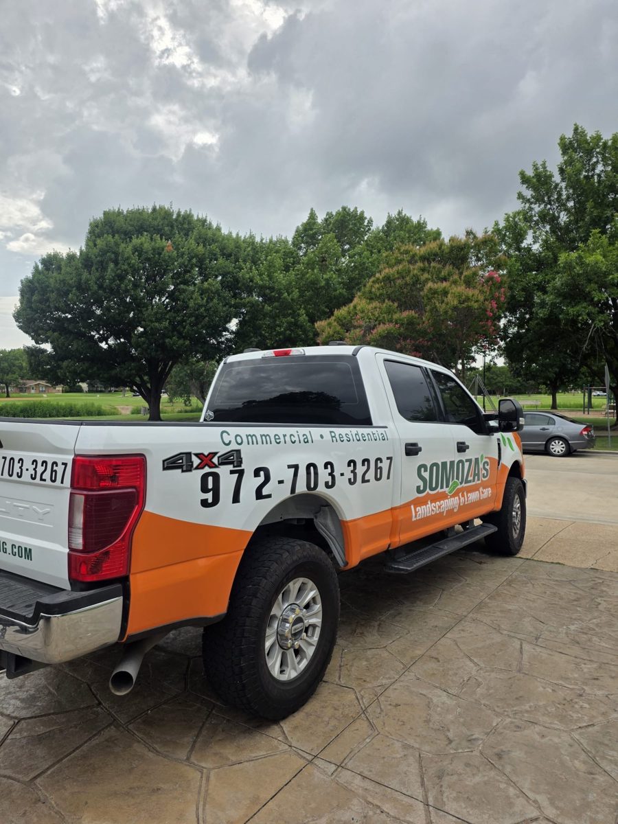 Somoza's Landscaping branded work truck at a job site